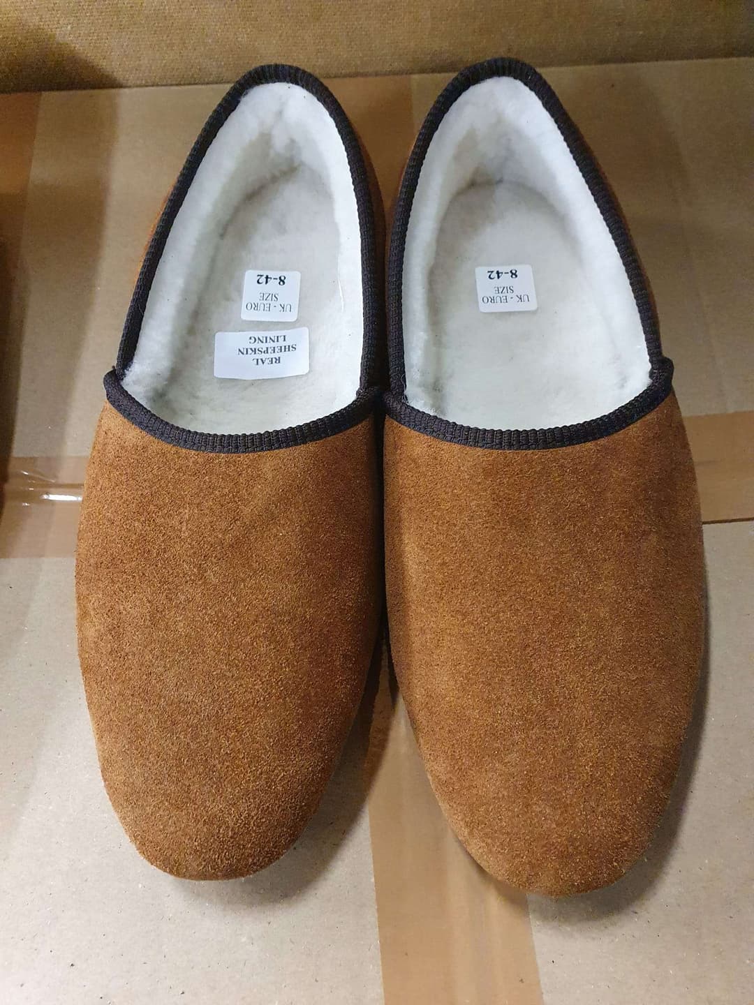A pair of tan turn slippers