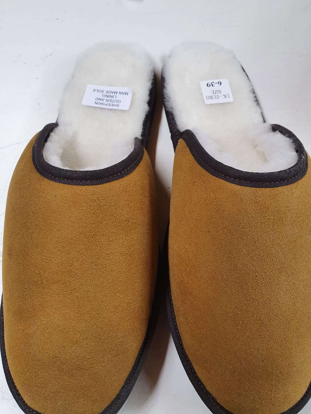 A pair of brown slippers